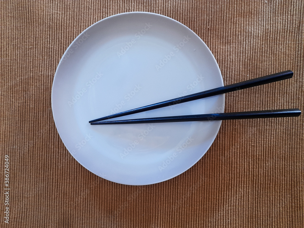 Empty white plate with chopsticks Empty white plate with chopsticks
