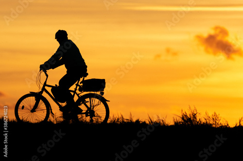 silhouette of a cyclist on the sunset