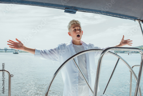 handsome Caucasian boy on the yacht 