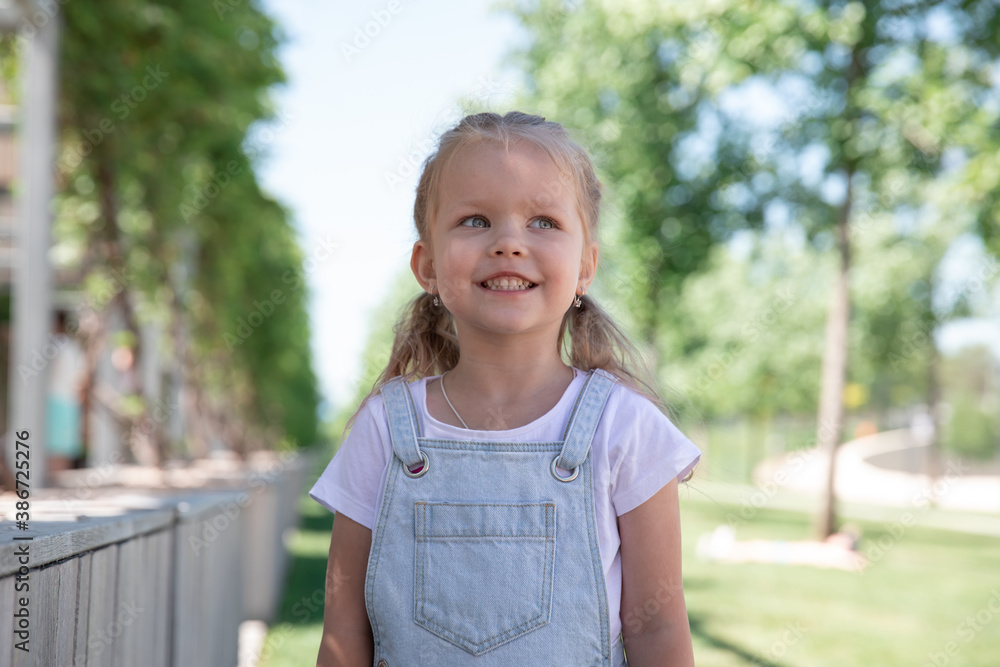 a little girl smiles, shows her teeth. large portrait. a little girl smiles, shows her teeth. large portrait.