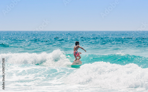 Teenage boy surfing in Atlantic Ocean - Cap Ferret, Aquitaine, France