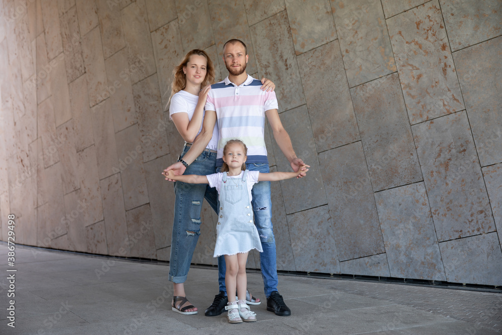 beautiful young family with a son, a daughter and children walking around the city. together. love beautiful young family with a son, a daughter and children walking around the city. together. love