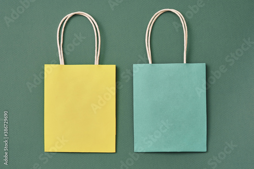 Yellow and blue paper gift bags. Copy space, flat lay, layout, top view