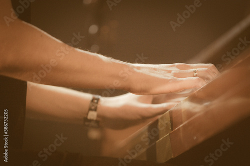 Close up fingers of pianist at the piano keys. Mens arms plays solo of music or new melody. Hands of male musician playing at synthesizer. Slow motion Top view Isolated shot.