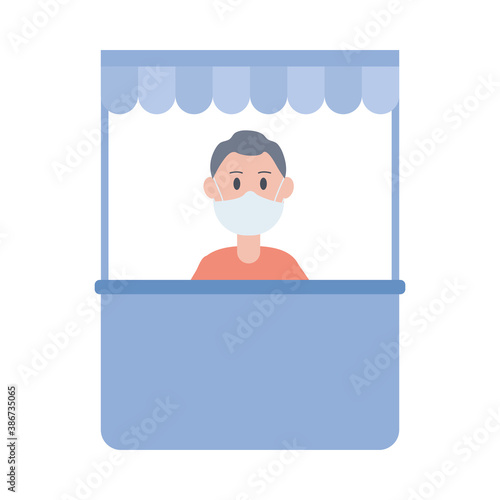 young man wearing face mask in ticket kiosk