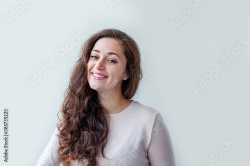 Happy girl smiling. Beauty portrait young happy positive brunette woman isolated on white background. Young european woman portrait, true emotions.