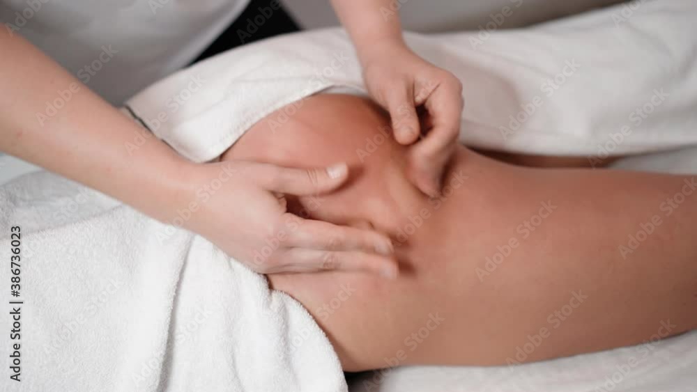 A woman massage therapist makes a powerful anti-cellulite massage of the buttocks to a female client in a cosmetic clinic. Skin care concept. Healthcare and medicine. Close-up A woman massage therapist makes a powerful anti-cellulite massage of the buttocks to a female client in a cosmetic clinic. Skin care concept. Healthcare and medicine. Close-up