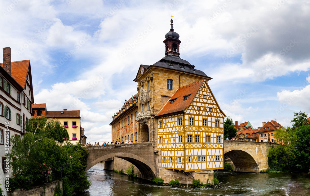 View of a yellow wooden house, bridges and river in Germany