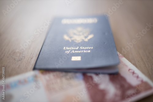 United States of America Passport with the Corner of a 10.000 Pesos Bill Inside