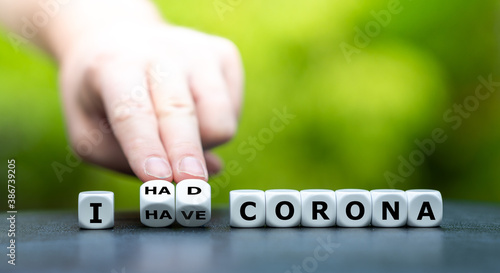Hand turns dice and changes the expression "I have corona" to "I had corona".