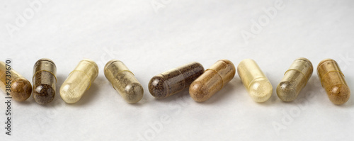 Various medical capsules on a white surface