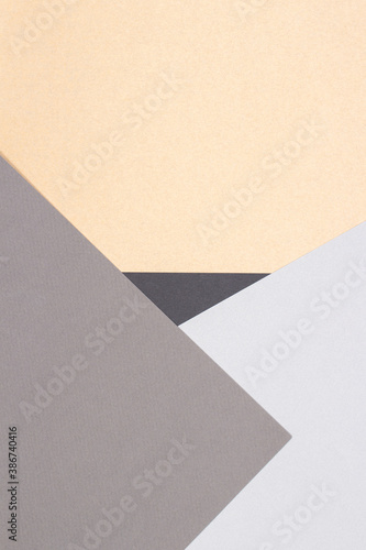 Creative abstract geometric paper background light gray, black colors and brown craft paper. Top view. Copy space