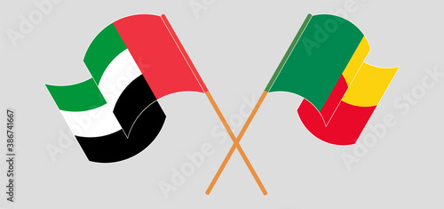 Crossed and waving flags of Benin and the United Arab Emirates
