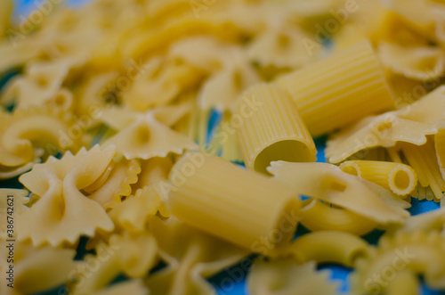 different pasta on a blue background.