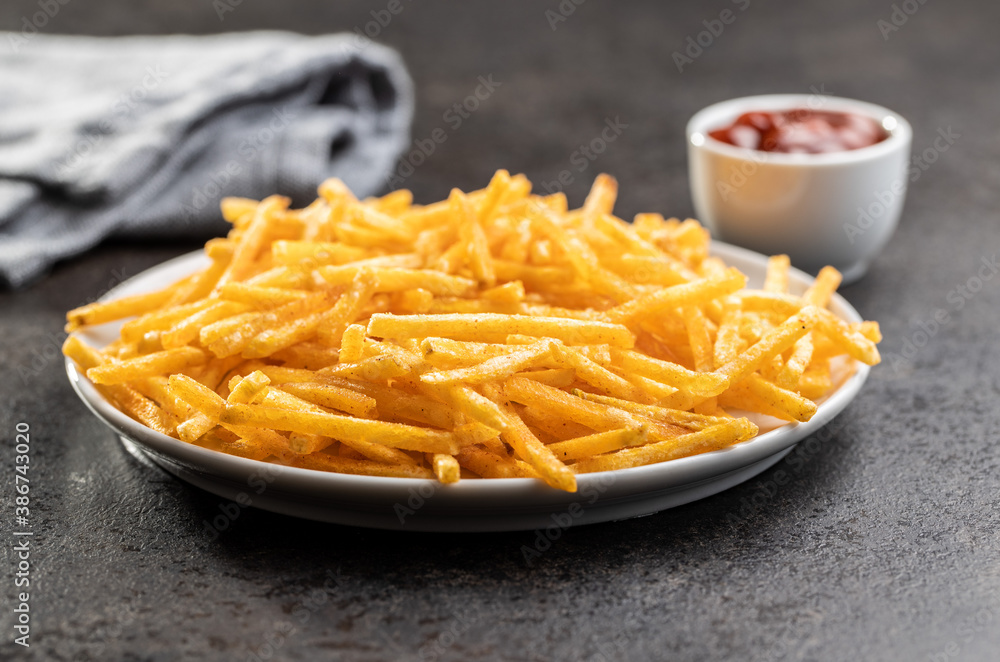 French fries. Fried mini potato sticks on plate. French fries. Fried mini potato sticks on plate.