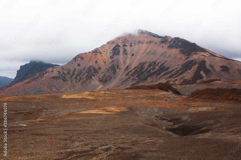 Hills, mountains and autumnal tundra, colored orange and red
