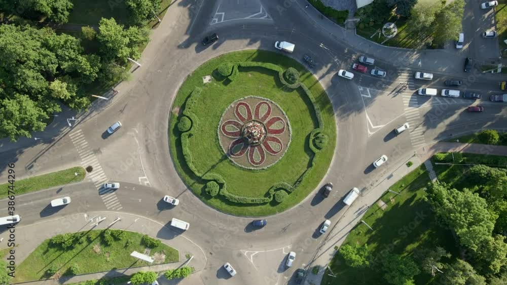 4k aerial view of roundabout road with circular cars in small european city at sunny day 4k aerial view of roundabout road with circular cars in small european city at sunny day