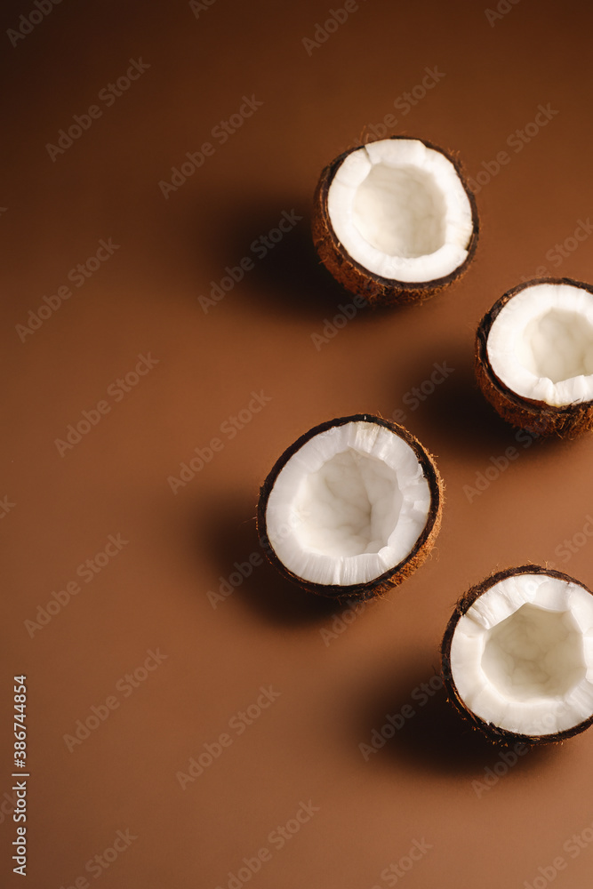 Coconut fruits on brown plain background, abstract food tropical concept, angle view copy space Coconut fruits on brown plain background, abstract food tropical concept, angle view copy space