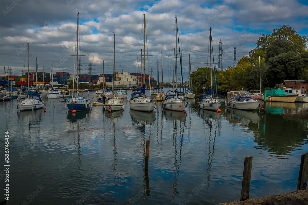 A view of boats moored on the River Test at Eling near Southampton, UK in Autumn