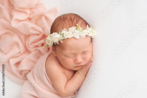 Photo of newborn baby sleeping at home. First days of life 