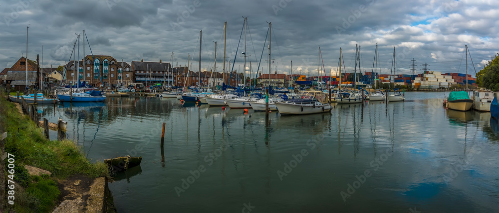 A panorama view of boats moored on the River Test at Eling near Southampton, UK in Autumn