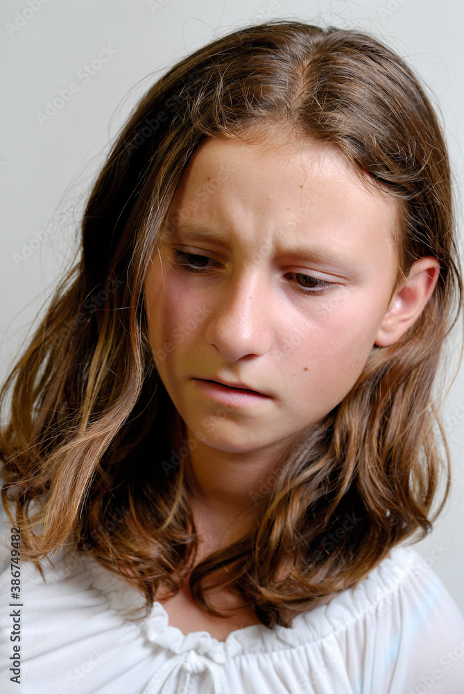 Sullen teenage girl looking down Sullen teenage girl looking down