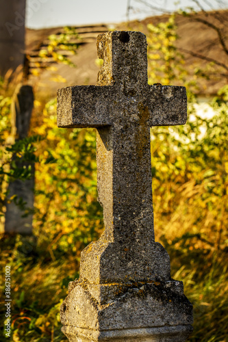 Statue of antique cross with the crucified Christ on the old 19th century cemetery. Ukraine