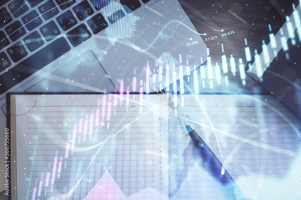 Stock market graph and top view computer on the table background. Multi exposure. Concept of financial education.