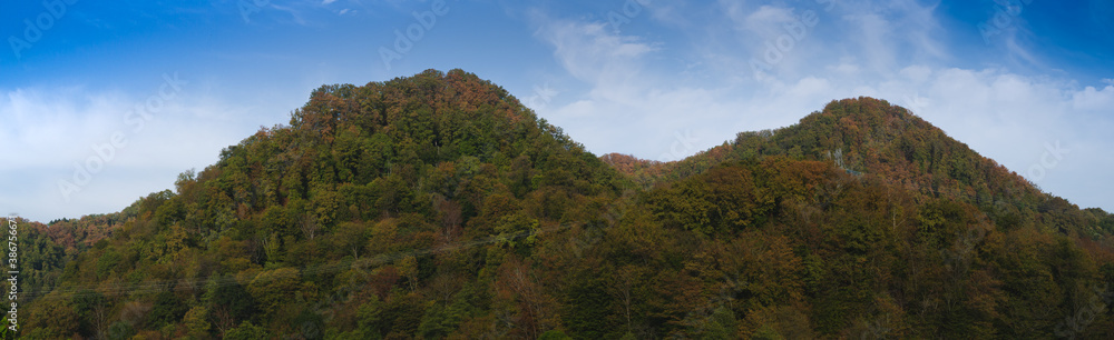 Panorama view of two forest mountains in autumn