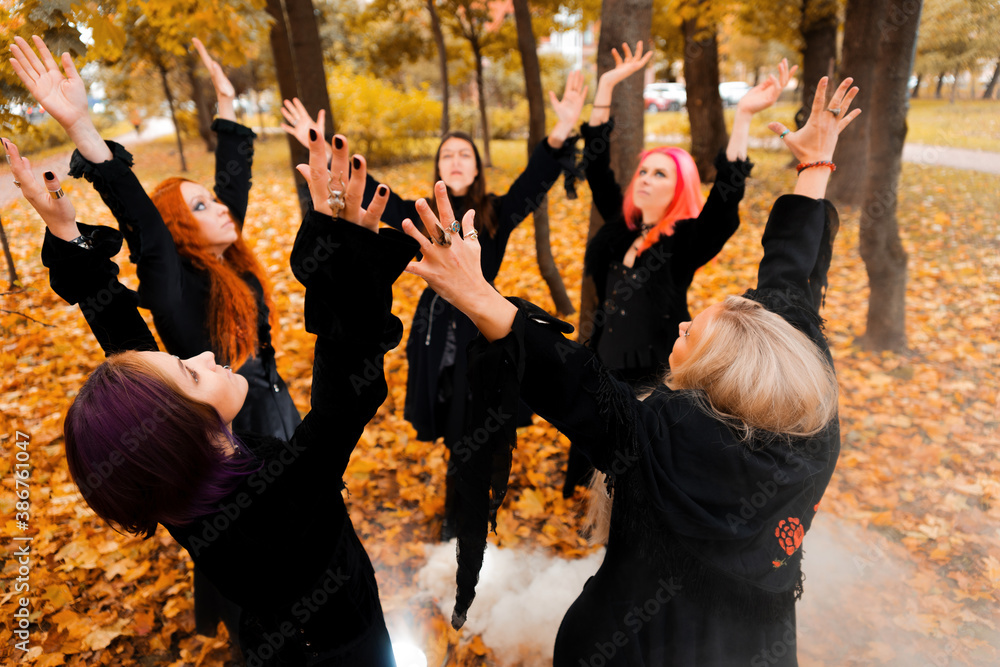 Coven of witches, a group of friends as witches on Halloween perform a