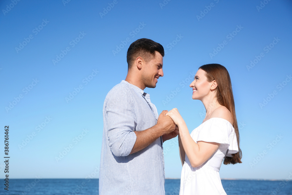 Lovely couple together on beach. Summer vacation Lovely couple together on beach. Summer vacation