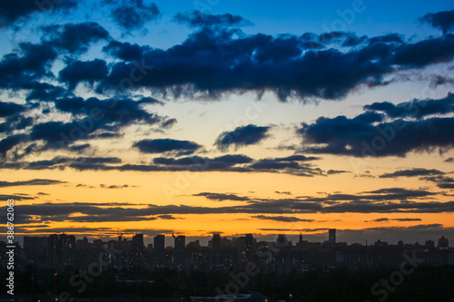 Beautiful sunset and clouds in the sunset orange and blue sky  big city view