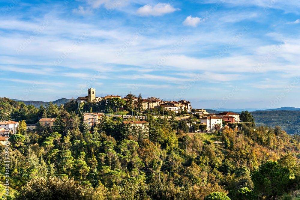Scenic view of Monterotondo Marittimo on a hill nestled in the woods in a sunny autumnal day, in Tuscany, Italy