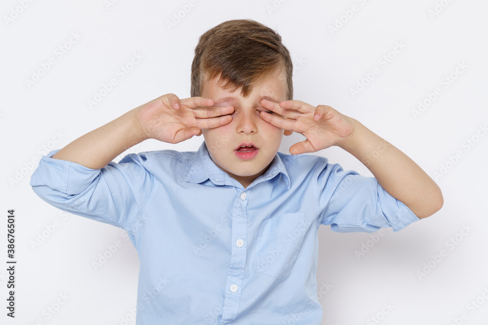 Portrait of a boy, covering his eyes with his hands. Isolated on white background. Portrait of a boy, covering his eyes with his hands. Isolated on white background.