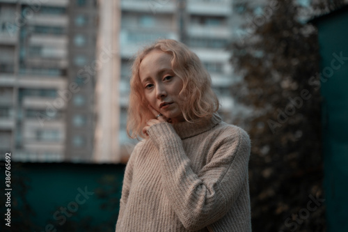 Portrait of a young girl on the background of a residential building photo