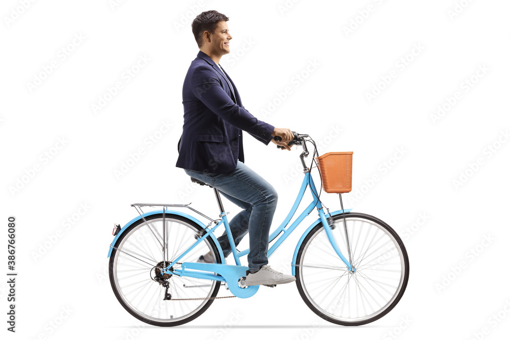 Profile shot of a young man riding a blue bicycle Profile shot of a young man riding a blue bicycle