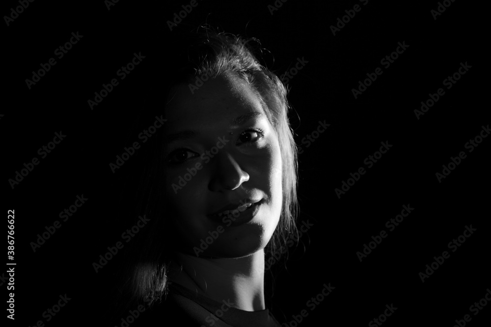 Black and white portrait of an Italian young woman on black background Black and white portrait of an Italian young woman on black background