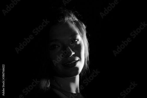 Black and white portrait of an Italian young woman on black background