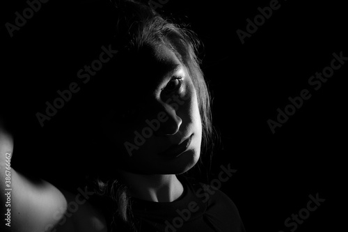 Black and white portrait of an Italian young woman on black background