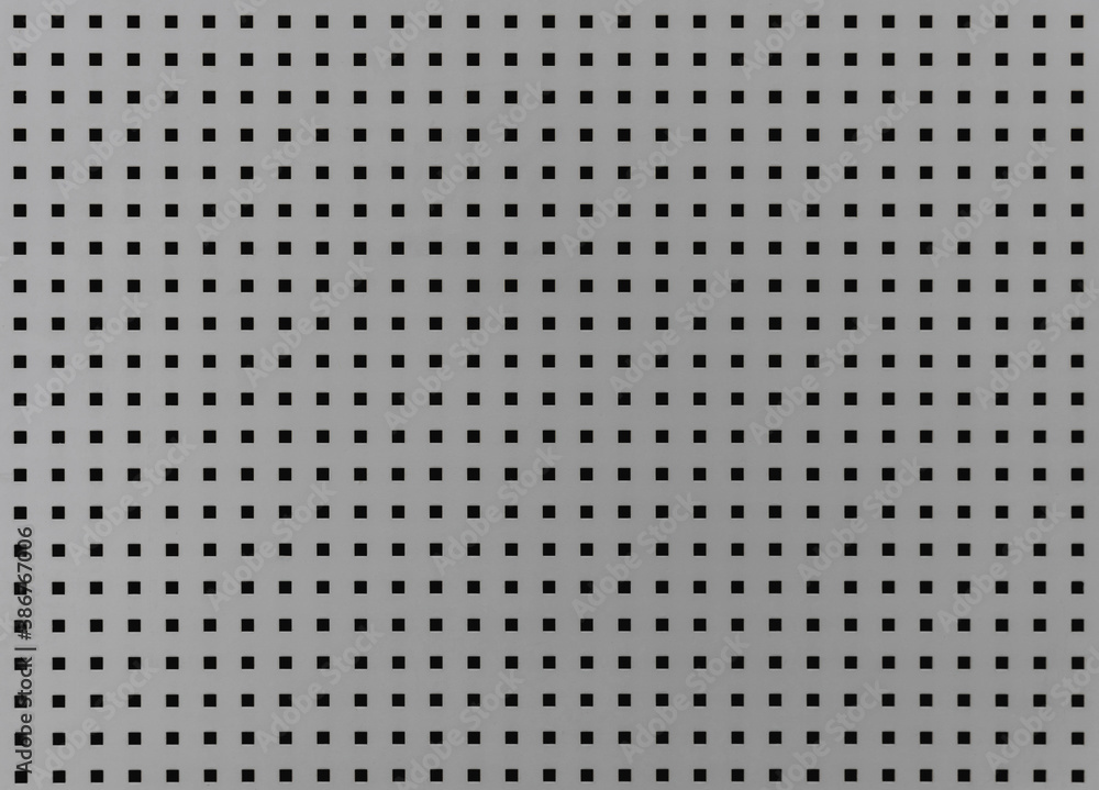 Background with many small square holes. Grey metal sheet with through square holes, textured iron. Metal grill with holes. Background with many small square holes. Grey metal sheet with through square holes, textured iron. Metal grill with holes.