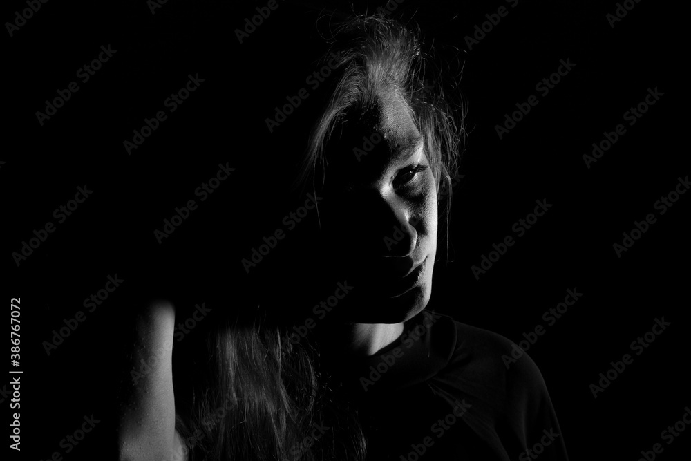 Black and white portrait of an Italian young woman on black background Black and white portrait of an Italian young woman on black background