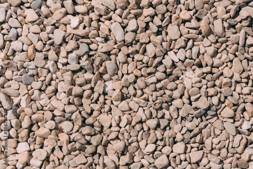 Top view of beidge pebbles stone texture and background. Colorful small pebbles or stone. Stone texture. Color small Rocks floor background. Sandstone. Top view of beidge pebbles stone texture and background. Colorful small pebbles or stone. Stone texture. Color small Rocks floor background. Sandstone.