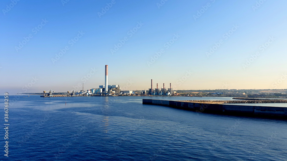 View of a large industry and its industrial smokestacks View of a large industry and its industrial smokestacks