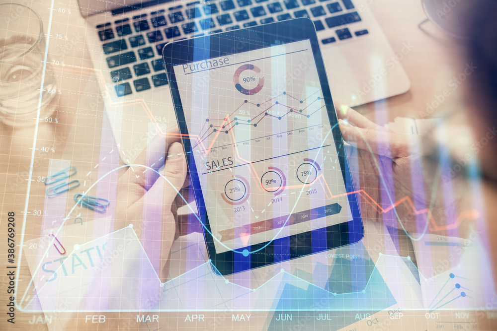 Double exposure of man's hands holding and using a digital device and forex graph drawing. Financial market concept. Double exposure of man's hands holding and using a digital device and forex graph drawing. Financial market concept.