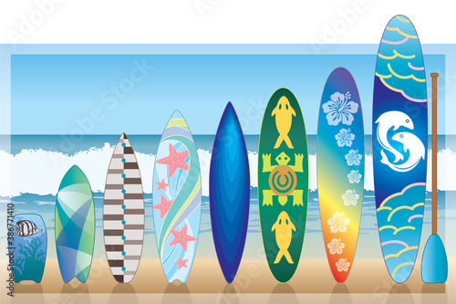variety of surfboards standing on the beach with sky, ocean and waves in the background