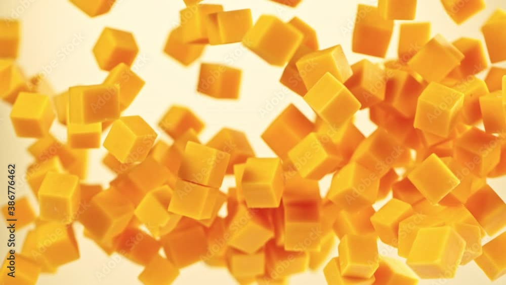 Super Slow Motion Shot of Flying Cheddar Cheese Cubes at 1000 fps. Super Slow Motion Shot of Flying Cheddar Cheese Cubes at 1000 fps.