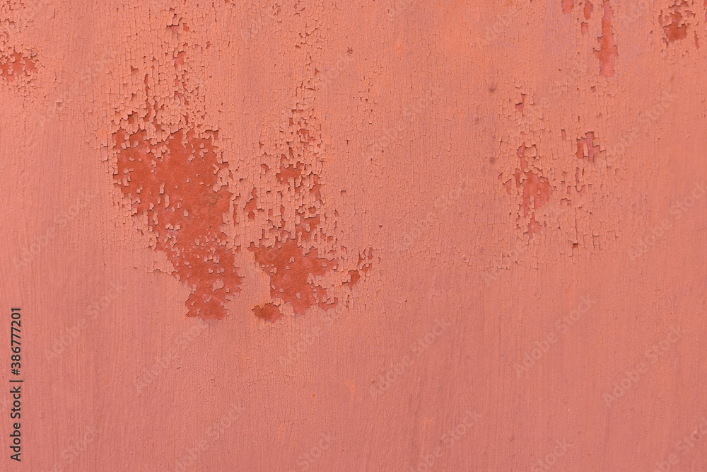 Fototapeta premium Texture in red. Matte surface. There is a patch on the texture, old texture with damaged paint. Texture with smudges of paint, cracked material from time and old age.