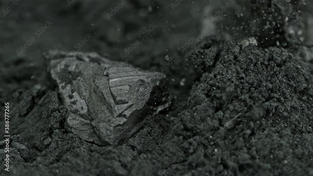 Super Slow Motion Shot of Coal Falling into Black Powder at 1000 fps. Super Slow Motion Shot of Coal Falling into Black Powder at 1000 fps.