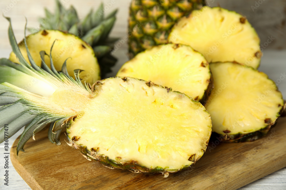 Slices of fresh pineapple on wooden board, closeup Slices of fresh pineapple on wooden board, closeup
