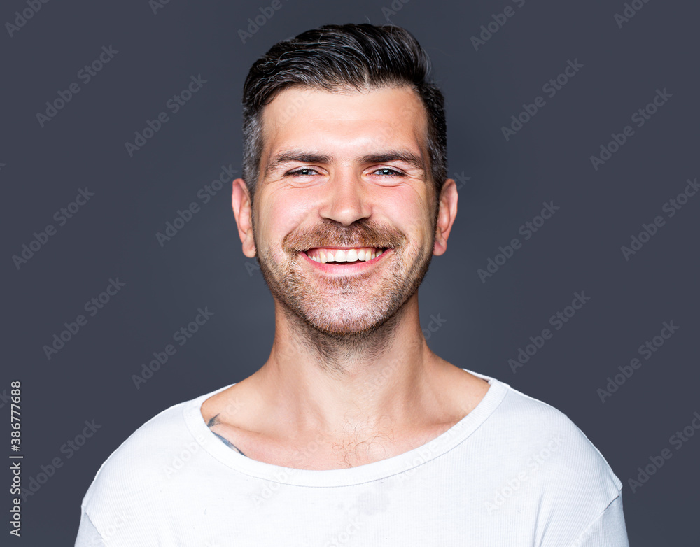 Fototapeta premium Portrait of happy smiling unshaven handsome man.